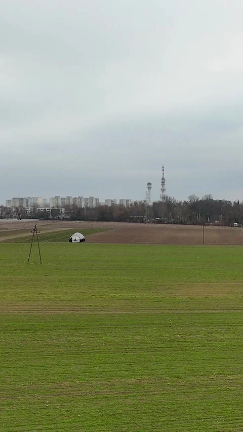 Vertical Drone Rising Over Field To Reveal Far City Horizon And Cloudy Sky Stock Footage 330751242