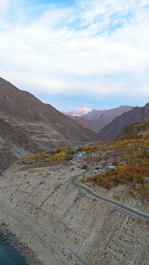 Vertical drone scene of a sparkling river and vibrant autumn view in kargil. Stock Footage 310661668