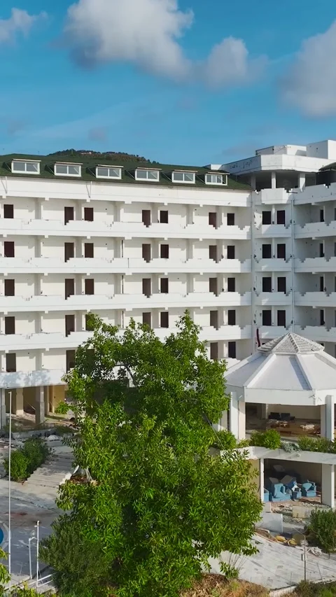 Vertical Drone Shot Abandoned Hotel Building with Repetitive Window Pattern Stock Footage 341715175