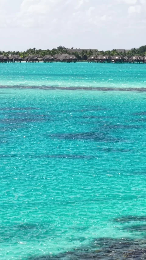 Vertical Drone Shot of Bora Bora Island Luxury Resort Bungalows and Lagoon Stock Footage 346614342