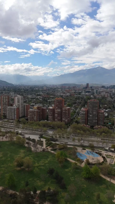 Vertical Drone Shot: Cinematic Pan Revealing Vitacura &amp; Parque Bicentenario, San Stock Footage 320737464