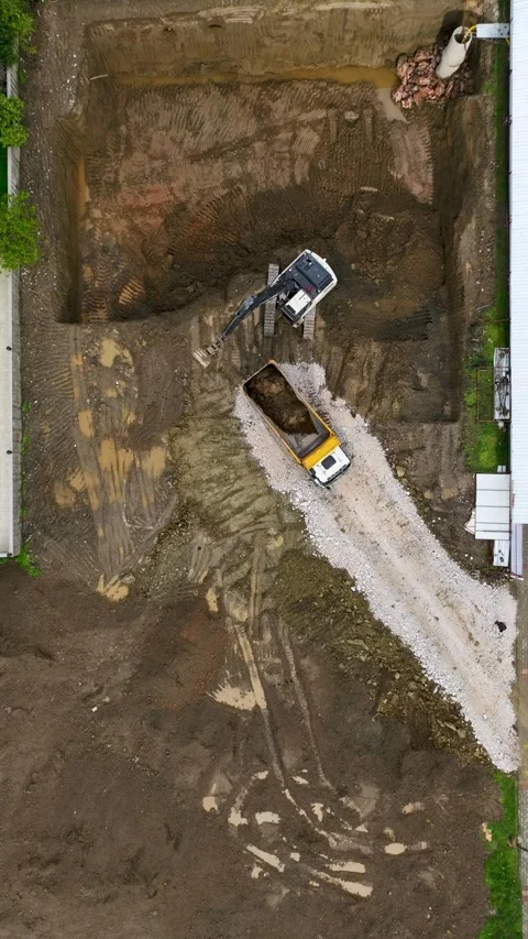 Vertical Drone Shot Construction Site Evolution with Crane Shadows and Dynamic Stock Footage 341679736