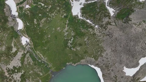 Vertical drone shot featuring a mountain lake and glaciers. Stock Footage 345184708