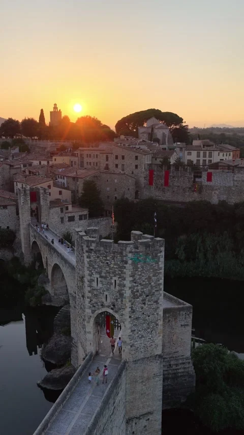 Vertical drone shot of medieval old bridge in Besalu, Girona Provence, Catalonia Stock Footage 320303764