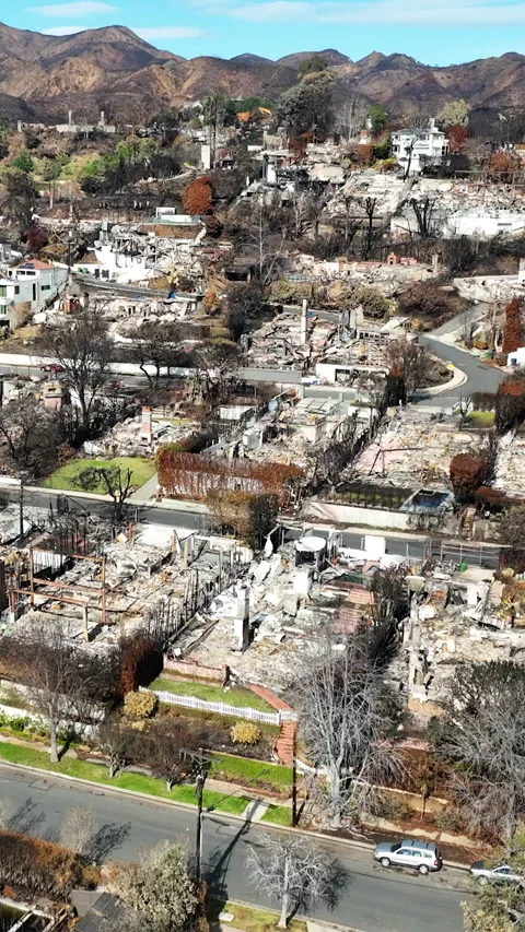 Vertical drone shot over house remains, in the hills of Pacific Palisades, LA Stock Footage 302130427