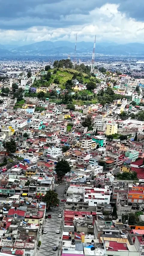 Vertical drone shot over red rooftops of Toluca, Mexico Stock Footage 348588030