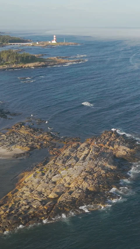 Vertical Drone Shot of Pointe-des-Monts Lighthouse on Quebec’s North Shore Video stock 327392079