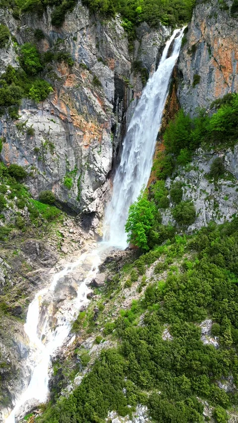Vertical Drone Shot Of Powerful Mountain Waterfall With Real Sound Effect Stock Footage 336638097