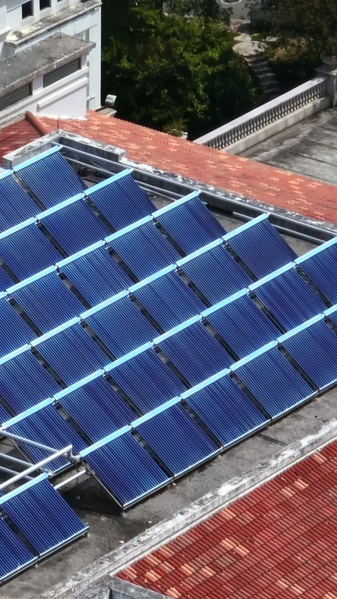 Vertical drone shot of reflecting solar panels on a roof in China, sunny day 動画素材 301622194