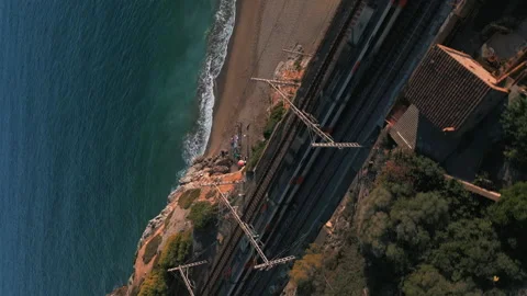 Vertical Drone shot of the Renfe train coming to Garraf train station Nov. 22 Stock Footage 223332107