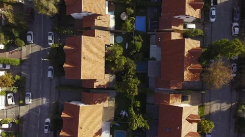Vertical drone shot of rooftops on suburban neighborhood. cars parked on a Stock Footage 332568479