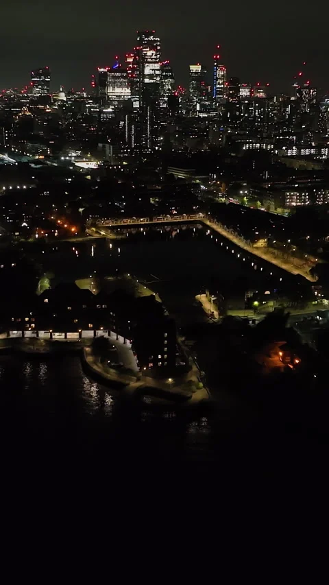 Vertical drone shot rotating in front of Shadwell Basin and London Skyline Stock Footage 337559619
