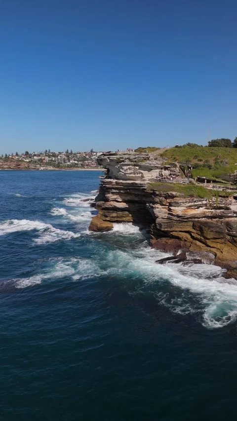 Vertical Drone Shot of Sandstone Cliffs and Turquoise Sea Vídeo Stock 332103689