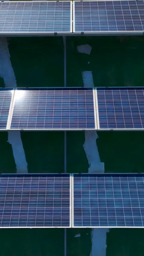 Vertical Drone Shot Solar Panels and Water Tanks on Urban Rooftop Stock Footage 341829012