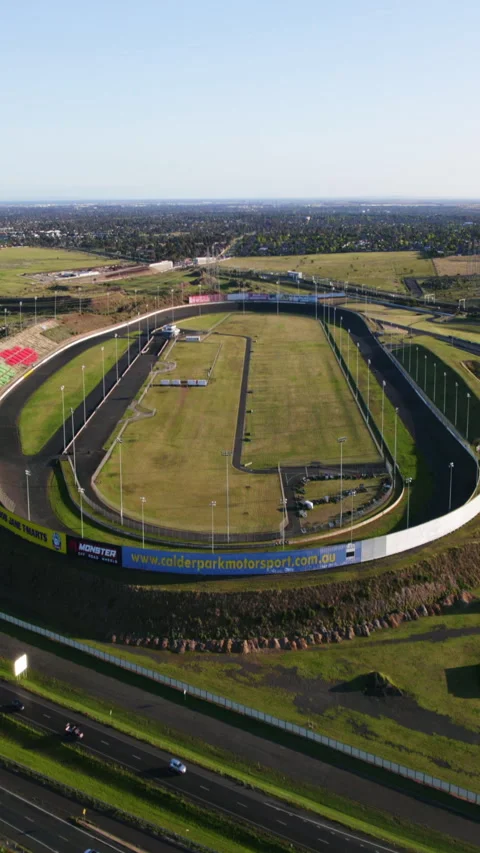 Vertical drone shot toward the Calder Park Thunderdome, in sunny Australia Stock Footage 293273365