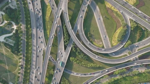 Vertical drone shot of traffic driving over massive intersection in China Stock Footage 67539040