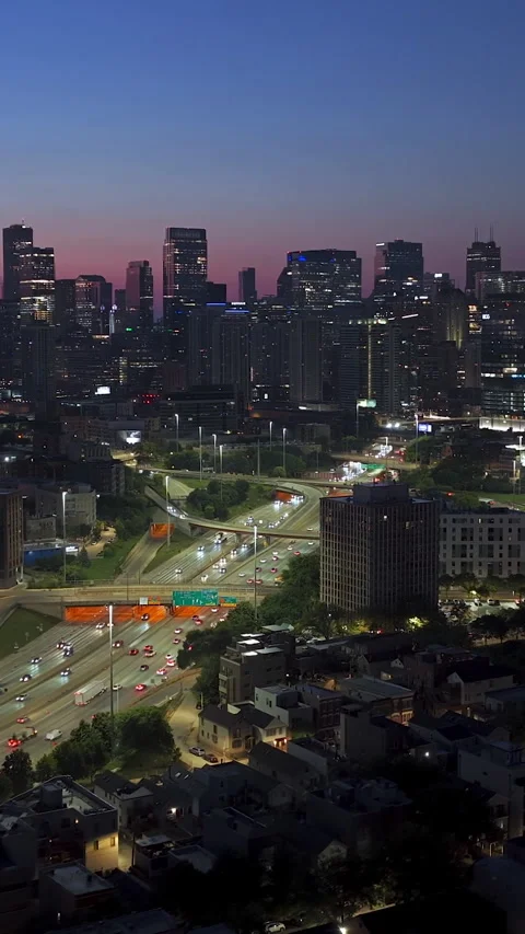 Vertical drone shot of traffic on interchange 90, dusk in River West, Chicago Stock Footage 324697687