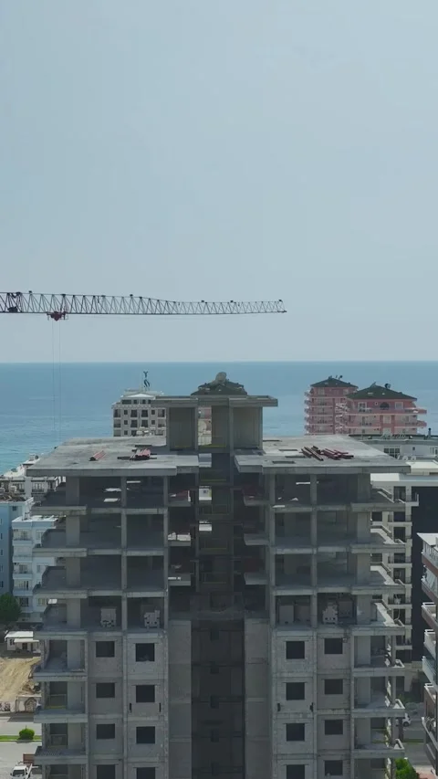 Vertical drone shot of workers moving materials inside multi level building Stock Footage 341788585