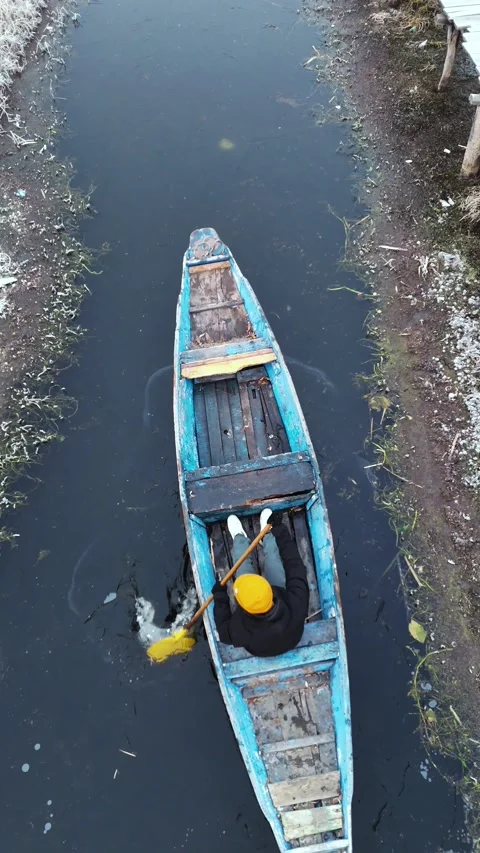 Vertical drone showcasing the gritty winter routine of boatmen slicing through Stock Footage 311019930