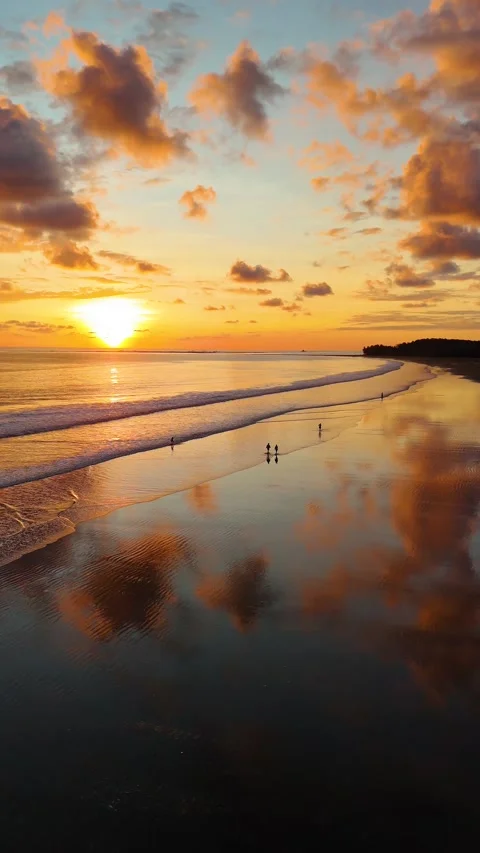 Vertical Drone Sunset Reflections on Wet Sand at Playa Uvita Stock Footage 328598296