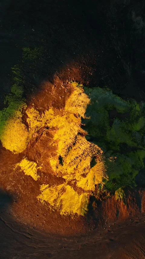 Vertical drone top-down of bright green volcanic moss on black ash and lava in Stock-Footage 330904645
