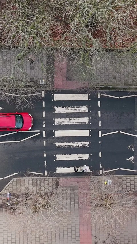 Vertical drone top-down over cars stopped at zebra crossing for passenger 動画素材 327788162
