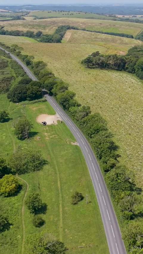 Vertical drone tracking along Brading Down Road, westbound over fields Stock Footage 339045339