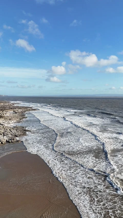 Vertical Drone Tracking Backwards Over Ocean Waves and Coast 4K Stock-Footage 334069166