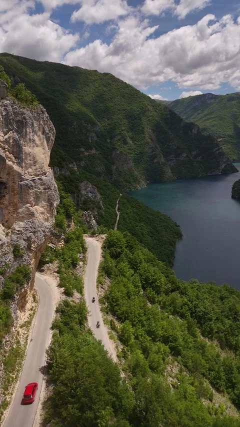 Vertical Drone Tracking of Car and Motorcycles on Mountain Cliff Road, 4K Stock Footage 337180055