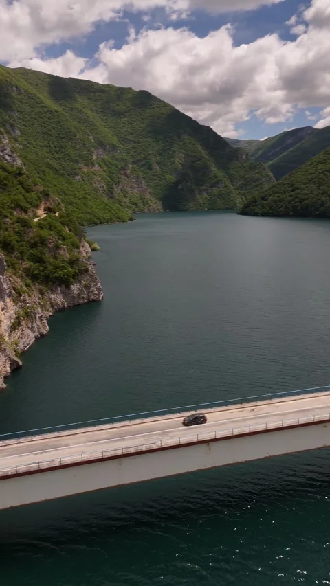Vertical Drone Tracking of Car Crossing Piva Lake Bridge in Montenegro, 4K Stock Footage 337180035