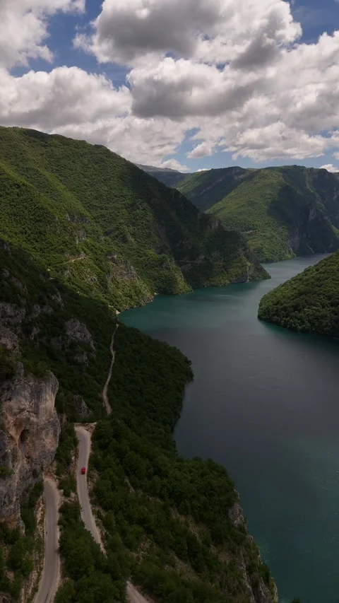 Vertical Drone Tracking of Car Driving Mountain Hairpin Turn in Piva Canyon, 4K Stock Footage 337180026