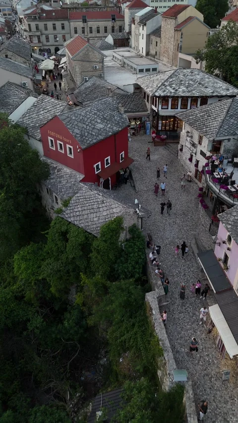 Vertical Drone Tracking Shot Over Mostar Old Town Shops and Cobblestone 4K Stock Footage 337830879