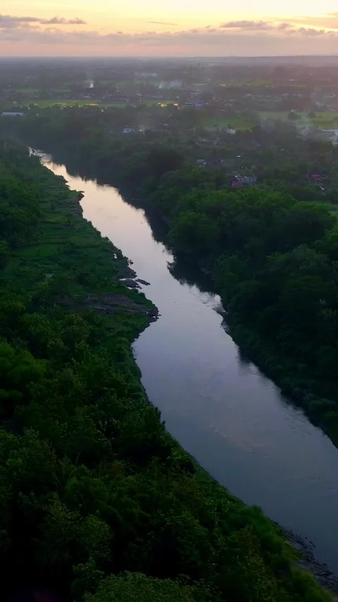 Vertical drone video above calm sunset river Stock Footage 336316605
