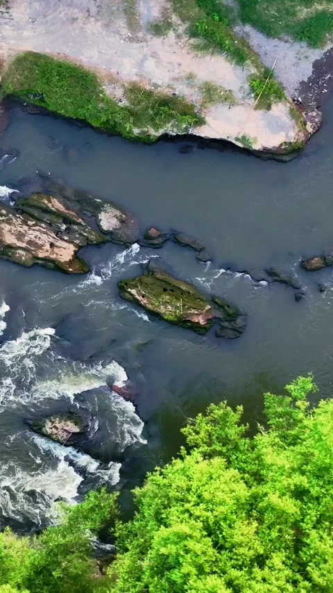 Vertical drone video above rocky river rapids Stock Footage 336316548
