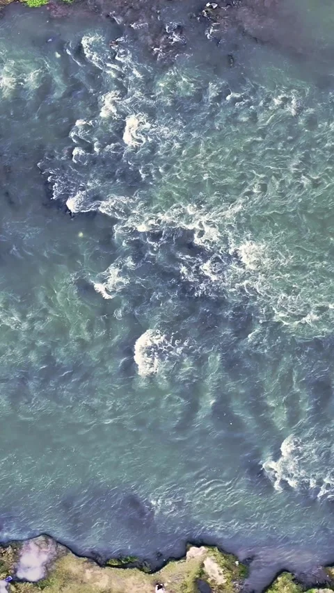 Vertical drone video above shallow river rapids Stock Footage 336316320