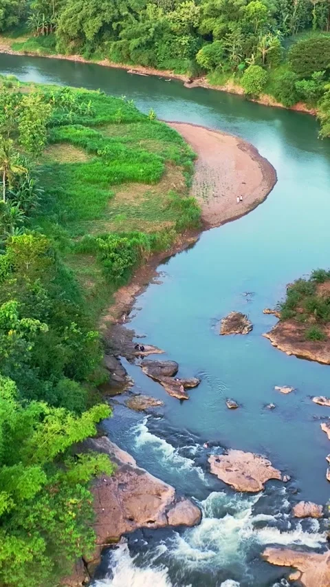 Vertical drone video of curved turquoise river Stock Footage 336316497