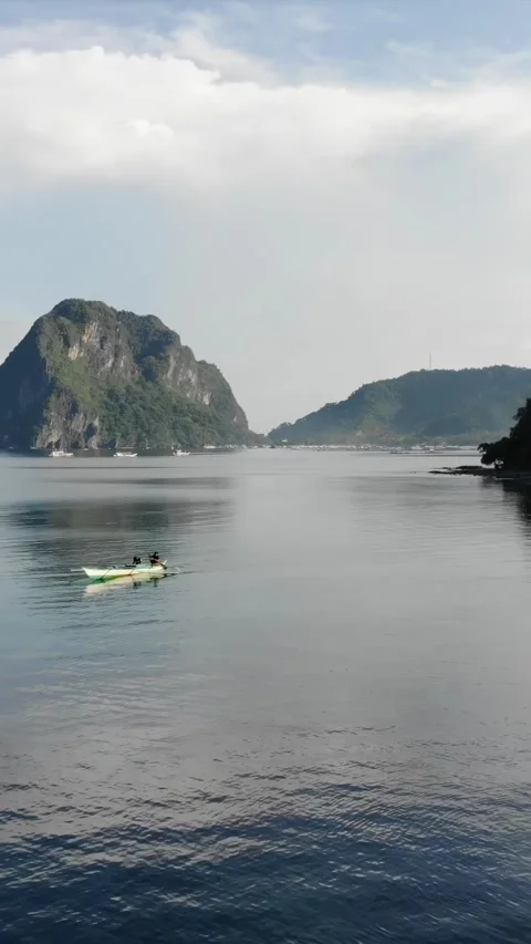 Vertical drone video of El Nido at sunrise from hidden beach Stock Footage 285825231