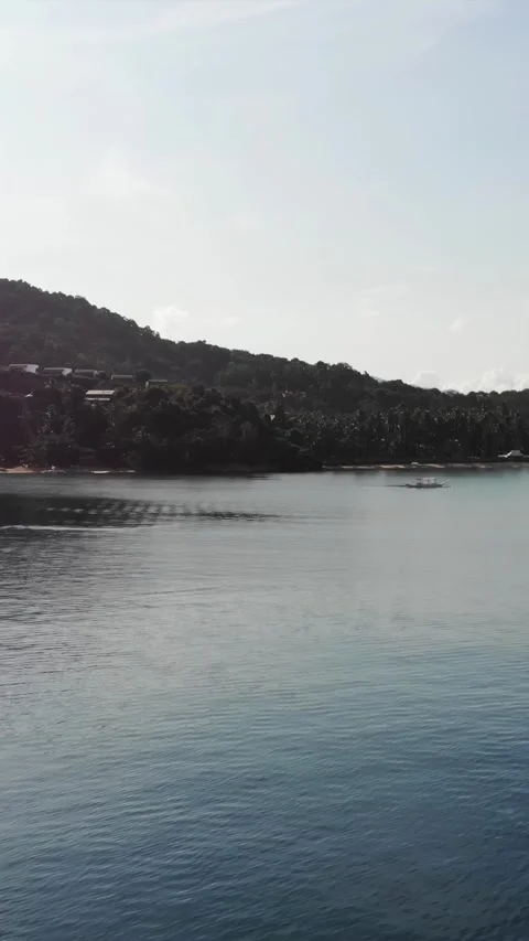 Vertical drone video of El Nido at sunrise from hidden beach Stock Footage 285826567