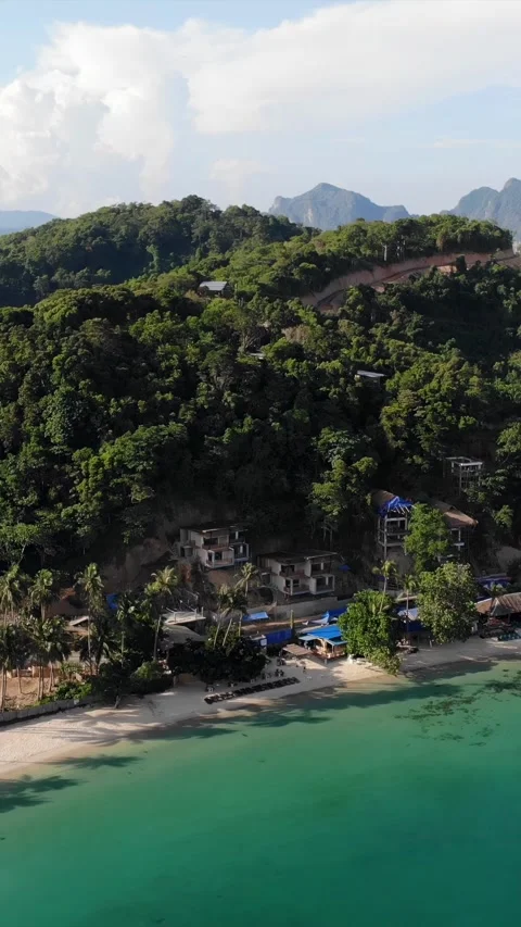 Vertical drone video of El Nido at sunrise from hidden beach Stock Footage 285828561