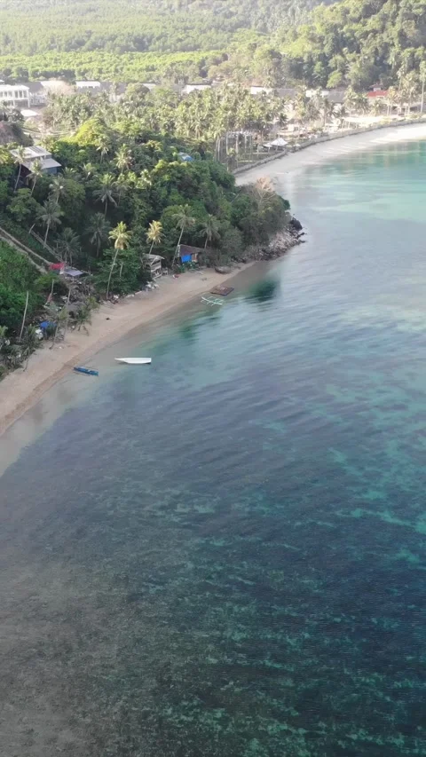Vertical drone video of El Nido at sunrise from hidden beach Stock Footage 285829473