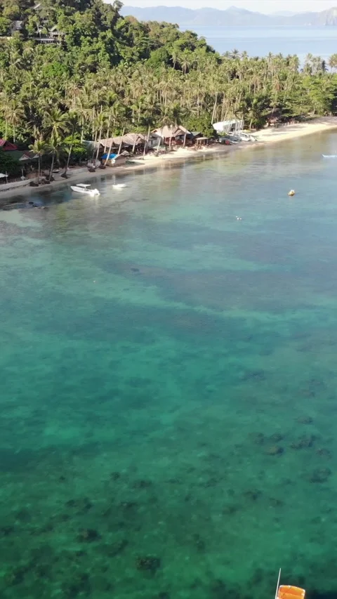 Vertical drone video of El Nido at sunrise from hidden beach Stock Footage 285830425