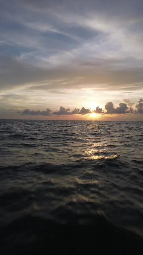 Vertical Drone Video Flying Backward Over Gulf of Mexico at Sunset Stock Footage 345963151