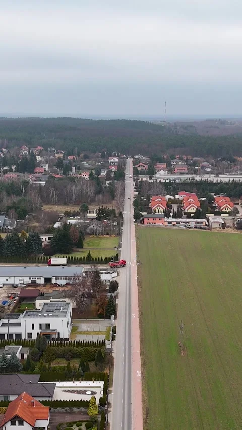 Vertical Drone Video Flying Forward Over Suburban Road Dividing Landscape Video stock 330751319