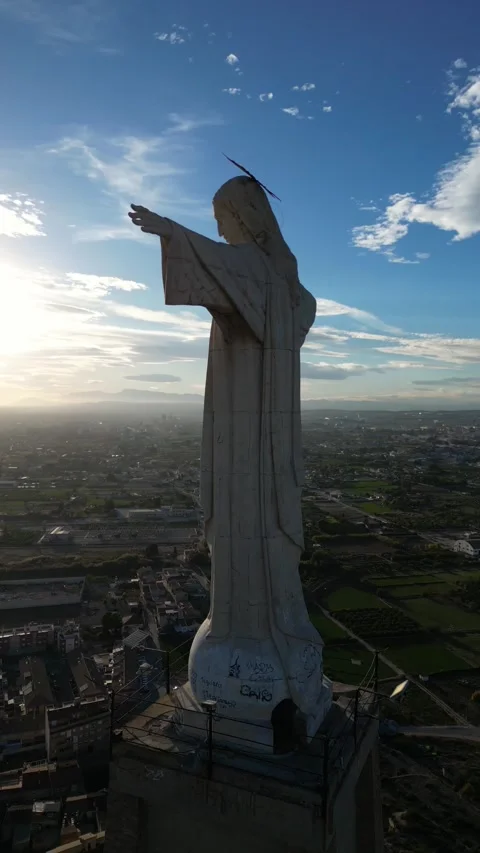 Vertical drone video. Religious statue of Jesus Christ with open arms. Flig.. Stock Footage 259740725