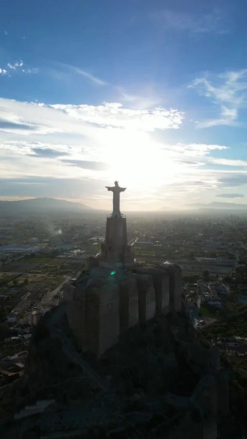 Vertical drone video. Statue of Jesus Christ on top of a mountain with open.. Stock Footage 259740721