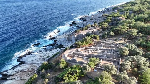 Vertical drone view of ancient stone ruins along a rocky shoreline. Stock Footage 327674719