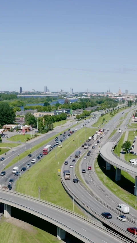 Vertical drone view of busy highway traffic in Riga, Latvia, leading toward Stock Footage 341851068