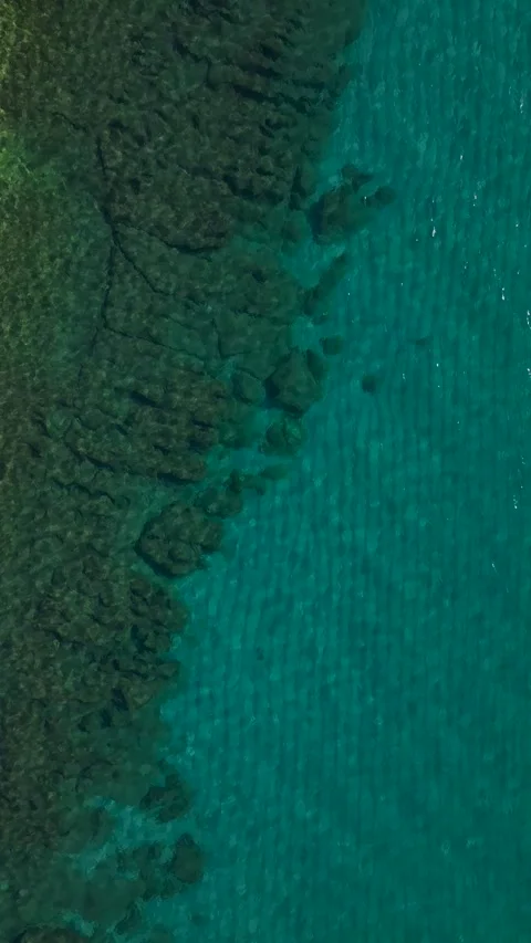 Vertical drone view of calm sea with natural wave pattern and turquoise gradient Stock Footage 341832763