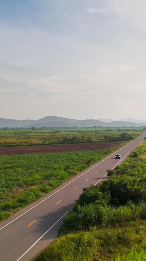 Vertical Drone View of Car fast Driving on Countryside Road Through Tropical 스톡 동영상 320286469