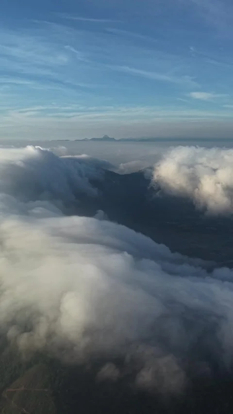 Vertical Drone View of Cloud Sea Cascading Over Mountain Peaks 스톡 동영상 343698256